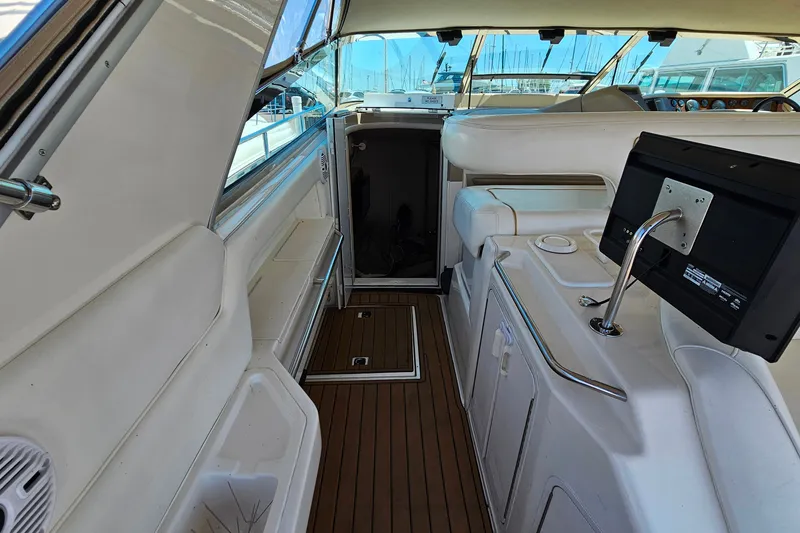 Slide: The Image of Interior view of a 1995 Sea Ray 500 Sundancer yacht with elegant seating and wood flooring. - 14