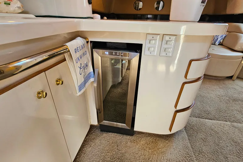 Slide: The Image of Interior of 1995 Sea Ray 500 Sundancer yacht with modern kitchenette and wine cooler. - 42