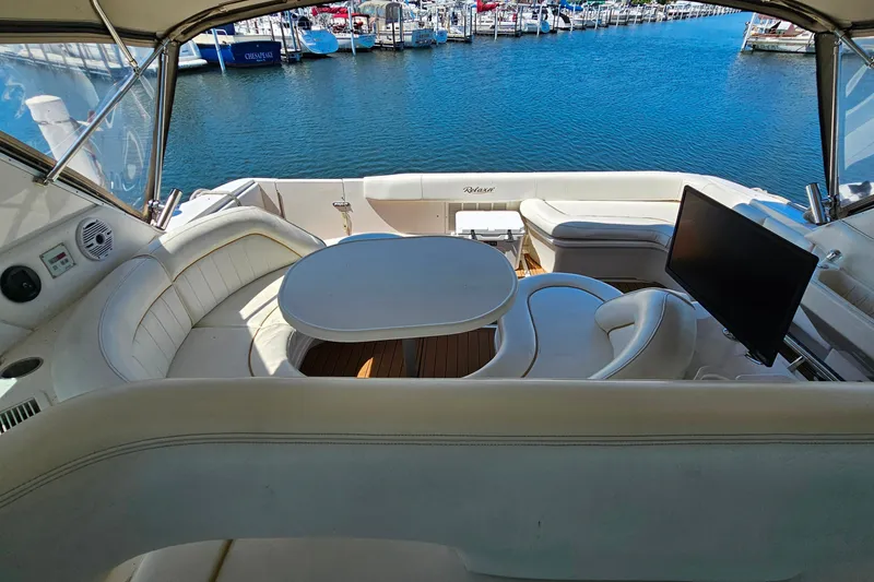 Slide: The Image of Luxurious 1995 Sea Ray 500 Sundancer yacht interior with seating, table, and marina view. - 23