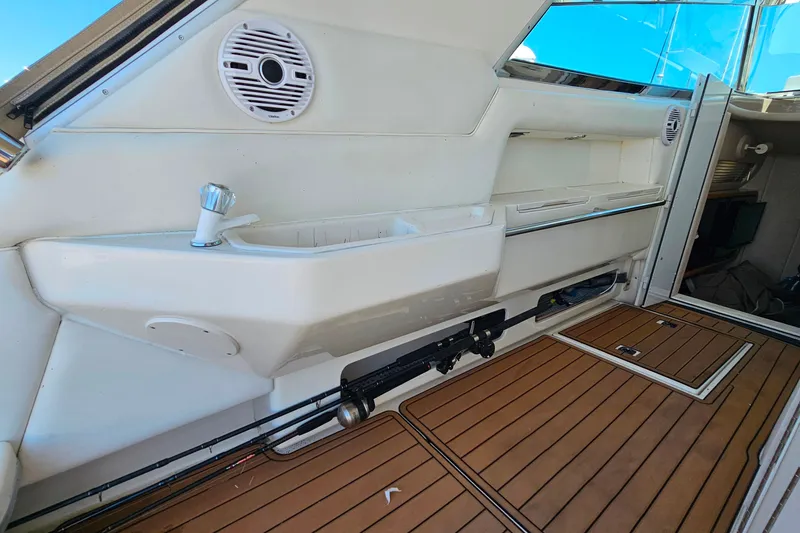 Slide: The Image of Interior view of 1995 Sea Ray 500 Sundancer yacht with wooden flooring and built-in sink. - 13