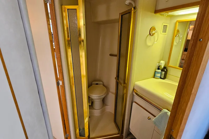 Slide: The Image of 1995 Sea Ray 500 Sundancer bathroom with shower, toilet, and vanity. - 40
