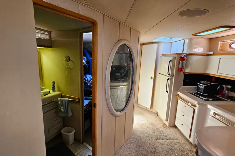 Slide: The Image of Interior of 1995 Sea Ray 500 Sundancer yacht, featuring kitchen and bathroom areas. - 28