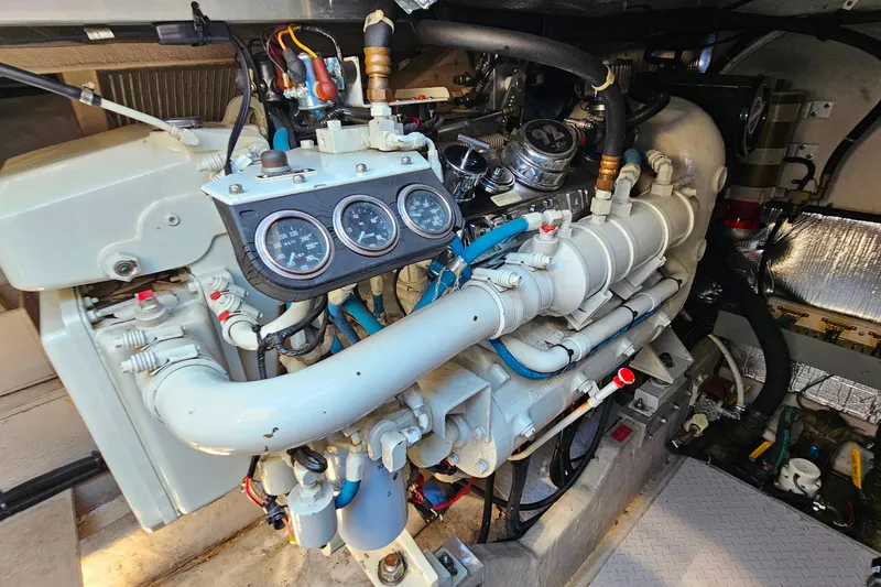 Slide: The Image of Engine compartment of a 1995 Sea Ray 500 Sundancer, showcasing detailed mechanical components. - 43