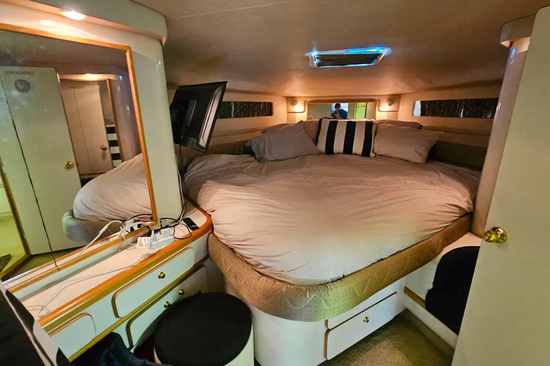 Slide: The Image of Luxurious cabin interior of 1995 Sea Ray 500 Sundancer yacht with cozy bed and vanity. - 34