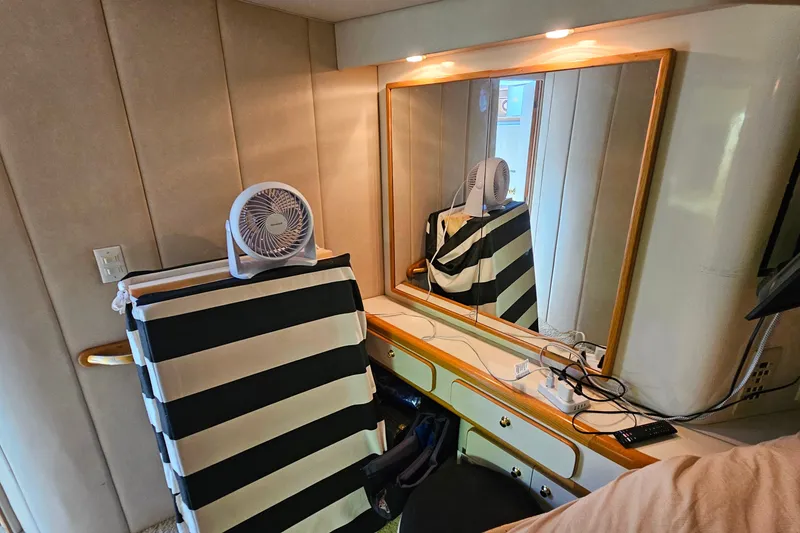Slide: The Image of Interior of 1995 Sea Ray 500 Sundancer with fan and striped chair reflected in mirror. - 37