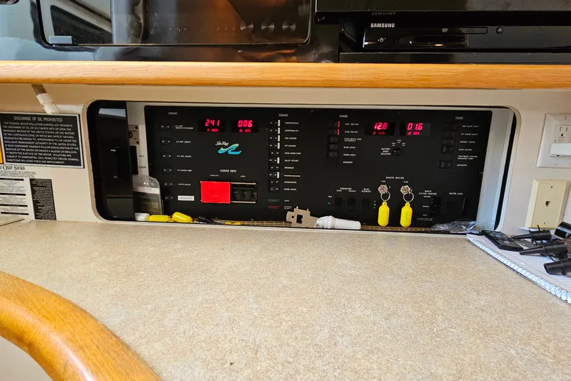 Slide: The Image of Control panel of a 1995 Sea Ray 500 Sundancer yacht with various switches and indicators. - 30