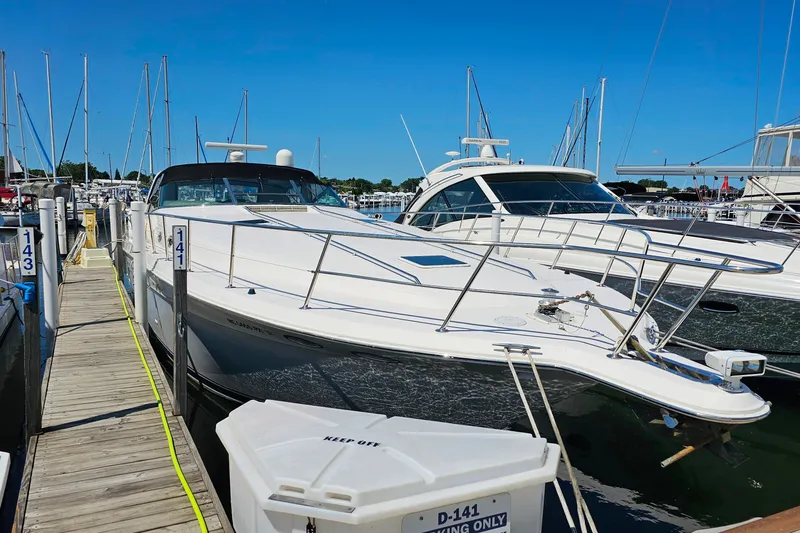 Slide: The Image of 1995 Sea Ray 500 Sundancer yacht docked at marina under clear blue sky. - 47