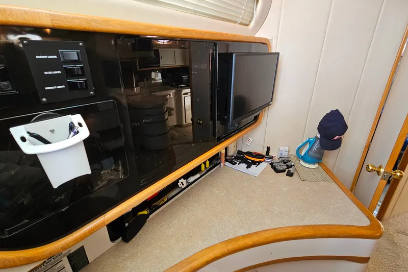 Slide: The Image of Interior of a 1995 Sea Ray 500 Sundancer with control panel and TV. - 25