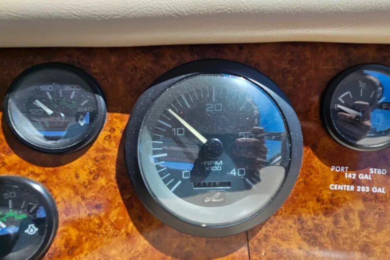 Slide: The Image of Dashboard gauges of a 1995 Sea Ray 500 Sundancer boat, showing RPM and fuel levels. - 19