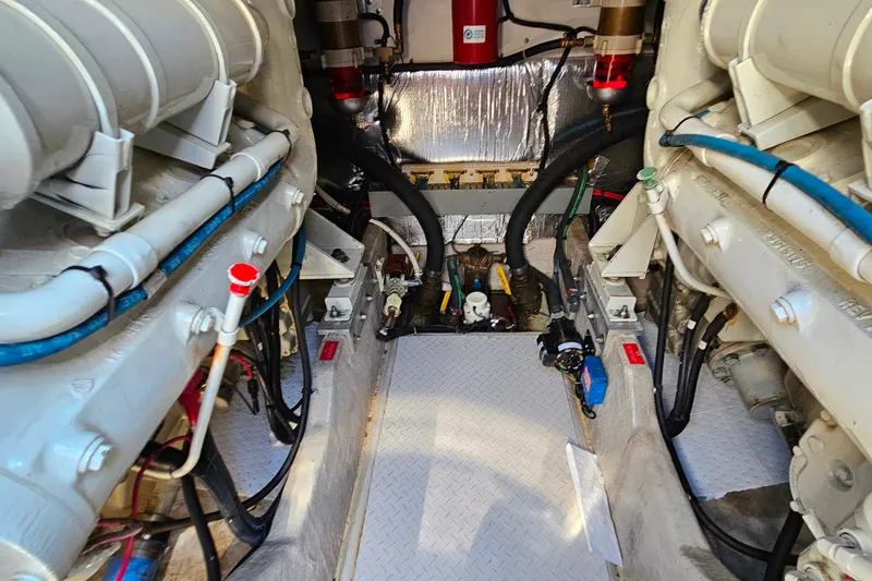 Slide: The Image of Engine room of a 1995 Sea Ray 500 Sundancer yacht, showcasing mechanical components. - 46