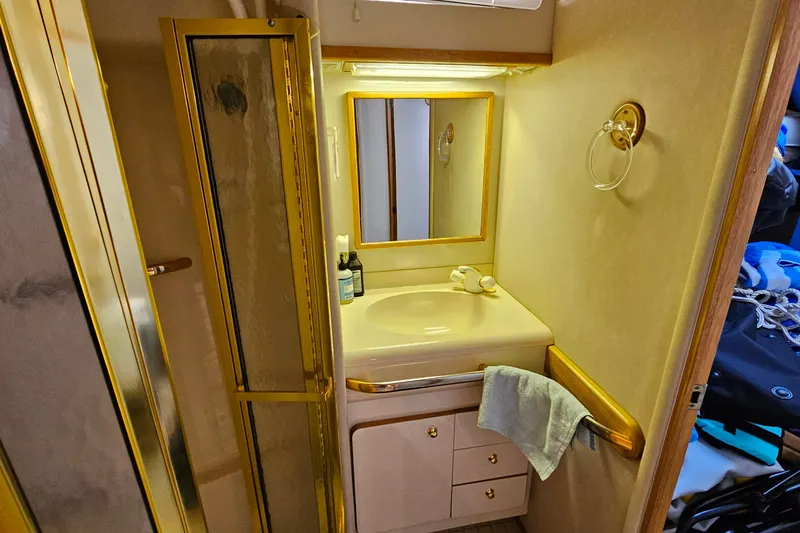 Slide: The Image of Bathroom interior of a 1995 Sea Ray 500 Sundancer yacht with sink and mirror. - 39