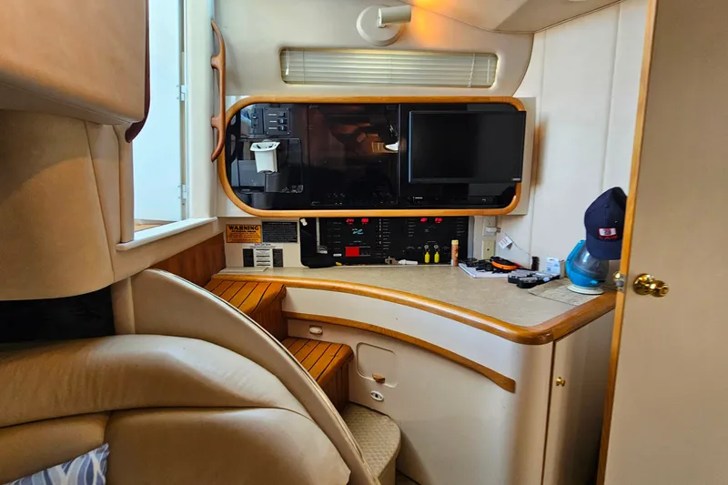 Slide: The Image of Interior of a 1995 Sea Ray 500 Sundancer yacht with control panel and seating area. - 29