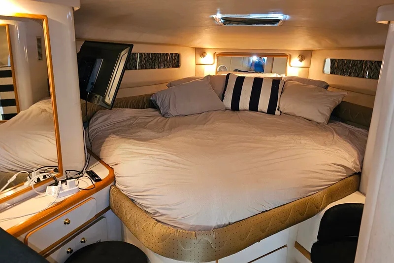 Slide: The Image of Luxurious cabin interior of a 1995 Sea Ray 500 Sundancer yacht with cozy bedding. - 35