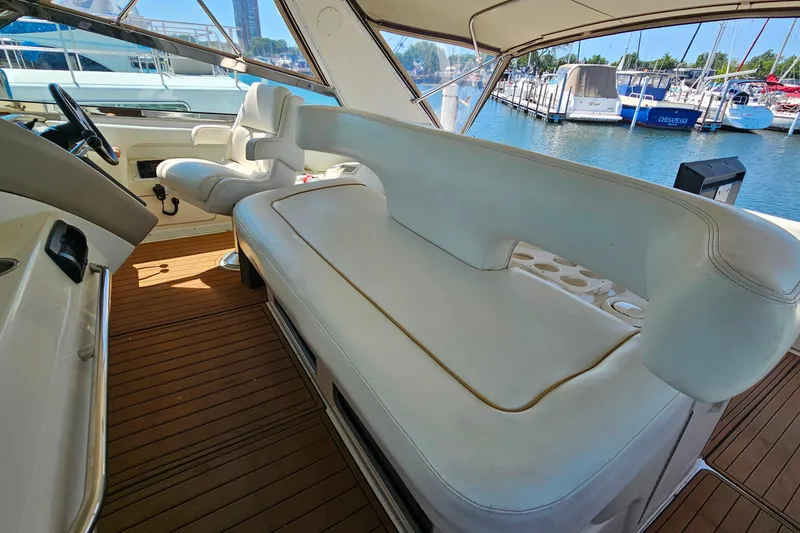 Slide: The Image of Interior of 1995 Sea Ray 500 Sundancer yacht with white seating and wooden flooring. - 15