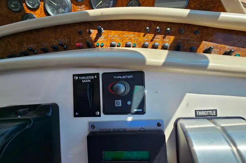 Slide: The Image of Control panel of a 1995 Sea Ray 500 Sundancer boat, featuring thruster and throttle controls. - 21
