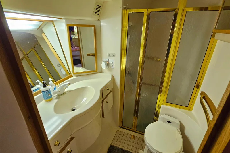 Slide: The Image of Luxurious bathroom in 1995 Sea Ray 500 Sundancer yacht with gold accents and modern amenities. - 38