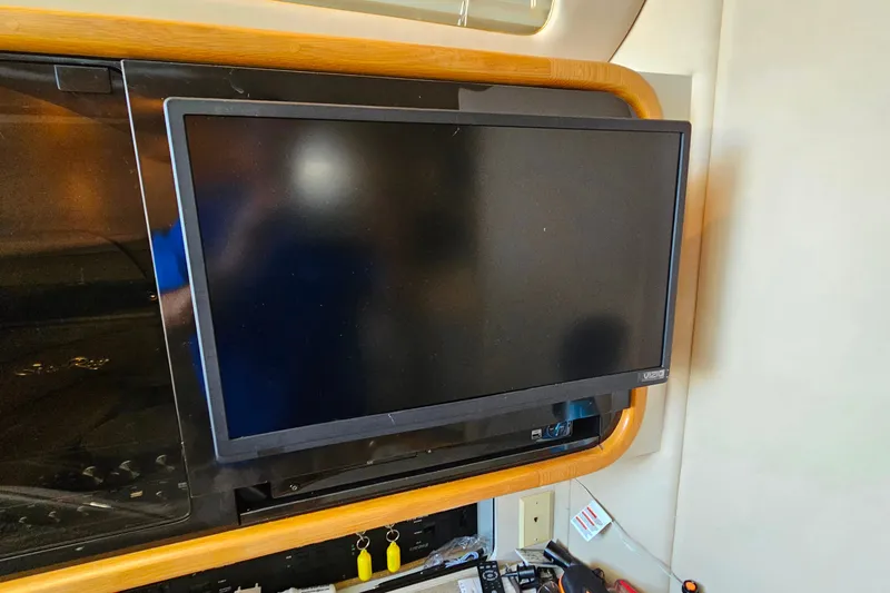 Slide: The Image of Flat-screen TV mounted inside a 1995 Sea Ray 500 Sundancer yacht interior. - 31