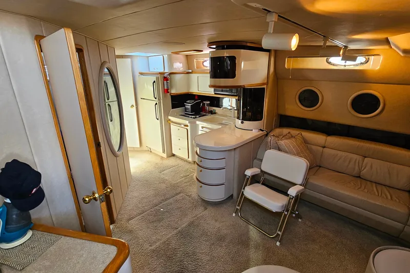 Slide: The Image of Interior of 1995 Sea Ray 500 Sundancer yacht with kitchen and seating area. - 24