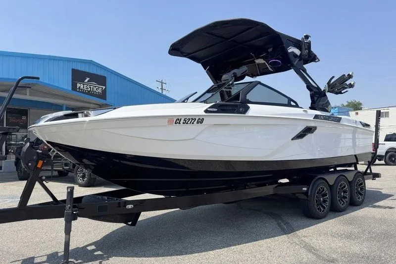 Slide: The Image of 2025 Centurion Ri245 boat on trailer outside Prestige dealership. - 15