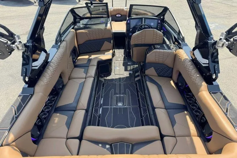 Slide: The Image of Luxurious interior of 2025 Centurion Ri245 boat with tan and black seating. - 6
