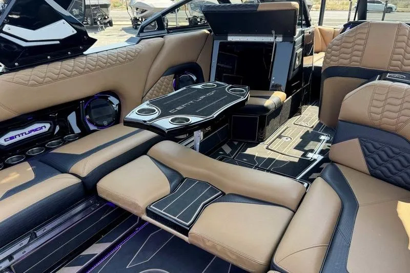 Slide: The Image of Luxurious interior of 2025 Centurion Ri245 boat with tan and black seating. - 17