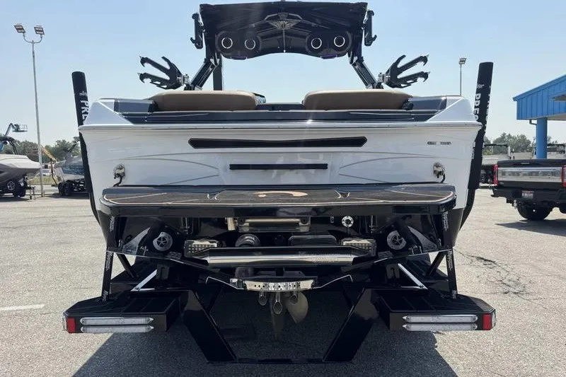 Slide: The Image of Rear view of a 2025 Centurion Ri245 boat in a parking lot. - 10
