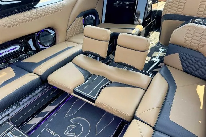 Slide: The Image of Luxurious interior of 2025 Centurion Ri245 boat with tan and black seating. - 3