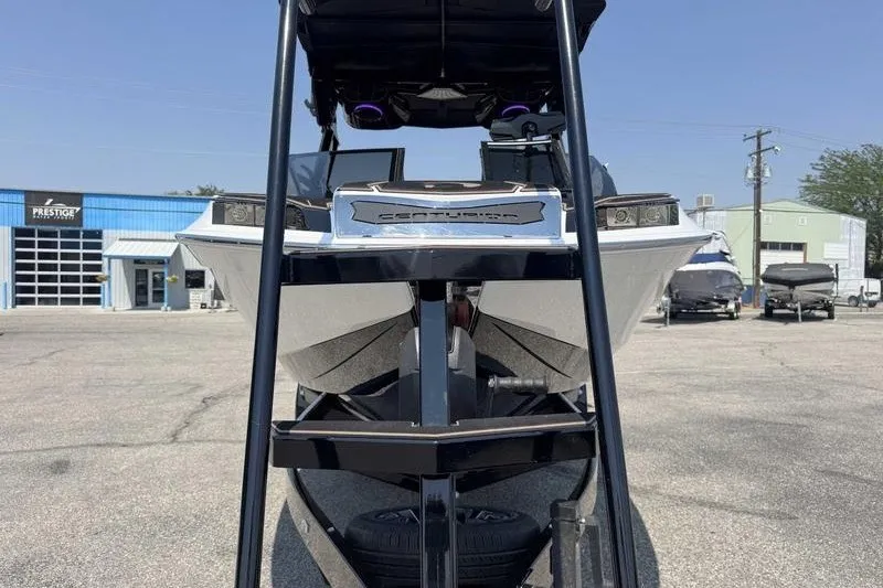 Slide: The Image of 2025 Centurion Ri245 boat front view at a dealership lot. - 9