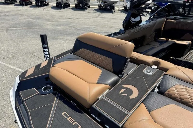 Slide: The Image of 2025 Centurion Ri245 boat interior with luxurious brown and black seating. - 11