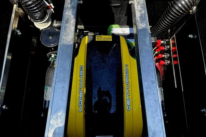 Slide: The Image of Engine compartment of a 2025 Centurion Ri245 boat, showcasing mechanical components and branding. - 2