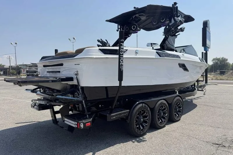 Slide: The Image of 2025 Centurion Ri245 boat on trailer, showcasing sleek design and modern features. - 13