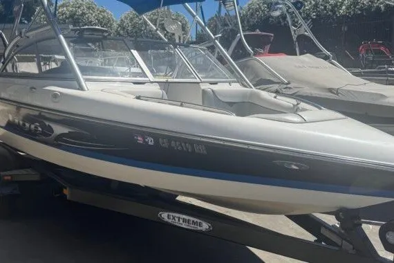 Slide: The Image of 2006 Tige 22i boat on trailer, featuring sleek design and blue accents. - 5