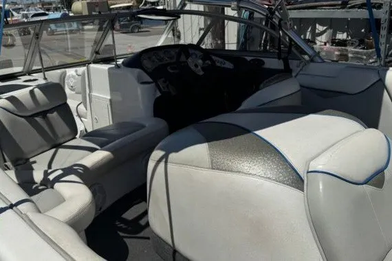 Slide: The Image of 2006 Tige 22i boat interior with white seating and dashboard view. - 3