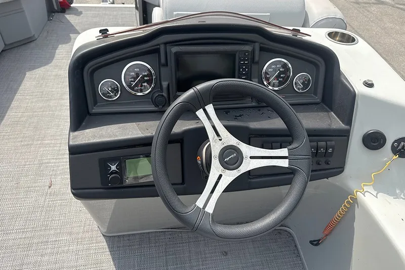 Slide: The Image of Steering console of 2023 Bentley Pontoons Legacy Navigator 223 with gauges and controls. - 7
