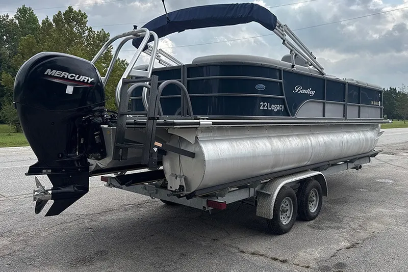 Slide: The Image of 2023 Bentley Pontoons Legacy Navigator 223 on trailer with Mercury outboard motor. - 8