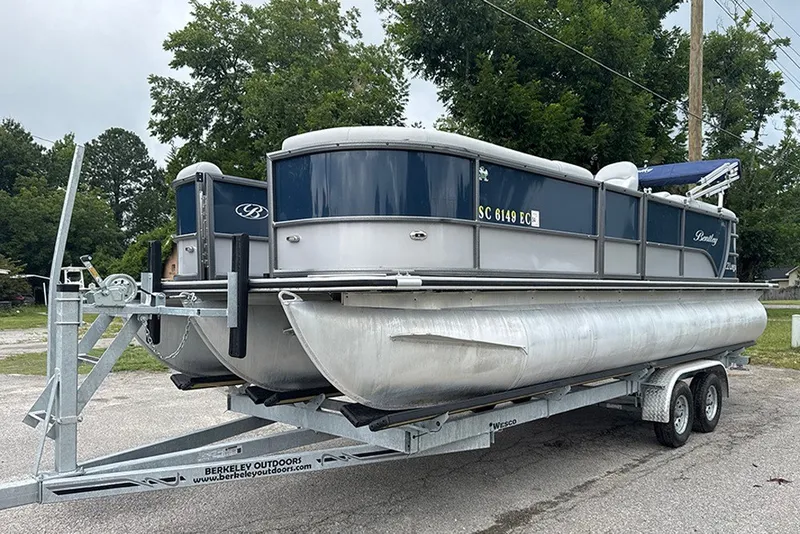 Slide: The Image of 2023 Bentley Pontoons Legacy Navigator 223 on trailer, parked outdoors. - 4