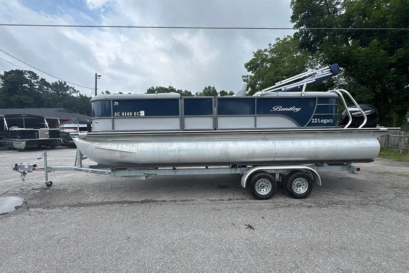 The Image of 2023 Bentley Pontoons Legacy Navigator 223 on trailer, parked outdoors. - 0