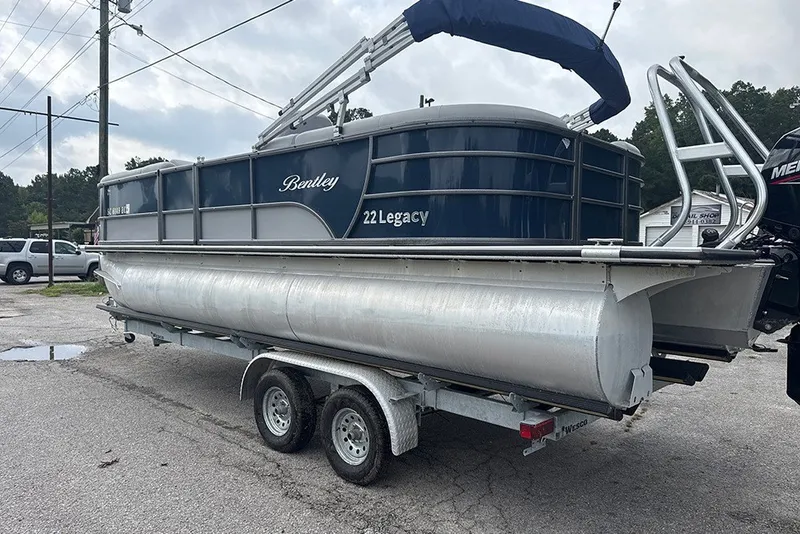 Slide: The Image of 2023 Bentley Pontoons Legacy Navigator 223 on trailer, parked outdoors. - 1
