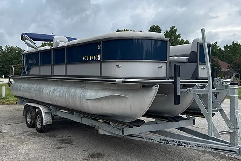 Slide: The Image of 2023 Bentley Pontoons Legacy Navigator 223 on trailer, parked outdoors. - 5