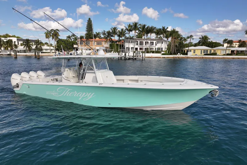Slide: The Image of 2022 SeaVee 390Z boat on water, featuring a sleek design and multiple outboard engines. - 37