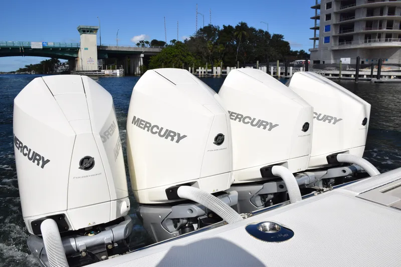 Slide: The Image of Four Mercury outboard engines on a 2022 SeaVee 390Z boat, dockside view. - 9