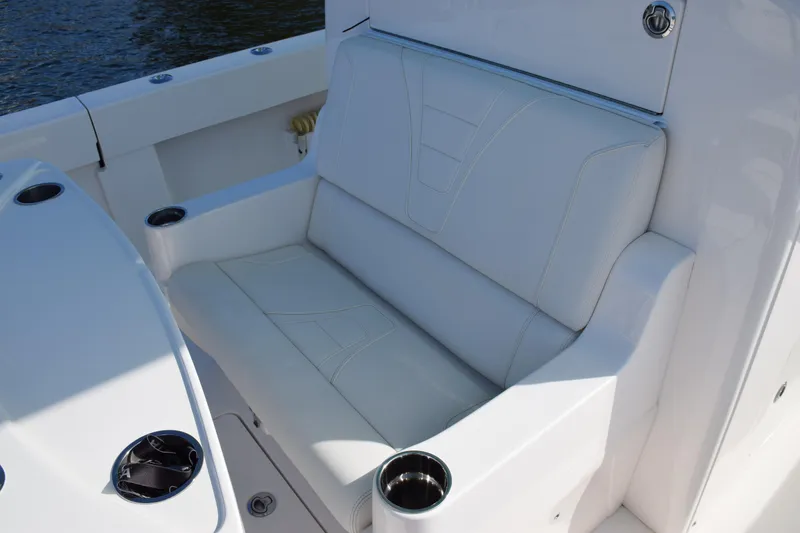 Slide: The Image of 2022 SeaVee 390Z boat with white cushioned seating and cup holders. - 16