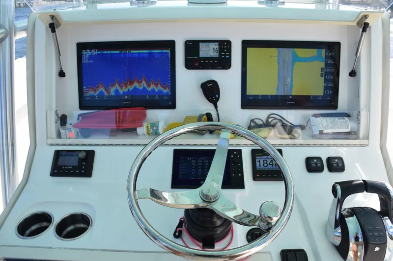 Slide: The Image of 2022 SeaVee 390Z helm with advanced navigation displays and controls. - 23