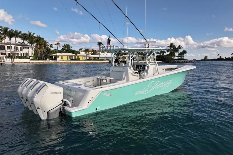 Slide: The Image of 2022 SeaVee 390Z boat with multiple outboard engines on calm water. - 40