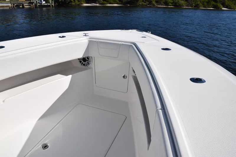 Slide: The Image of 2022 SeaVee 390Z boat interior, featuring sleek white seating and storage compartments. - 35