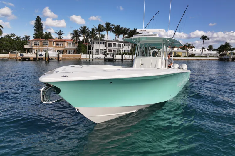 Slide: The Image of 2022 SeaVee 390Z boat on clear water, with luxury waterfront homes in the background. - 36
