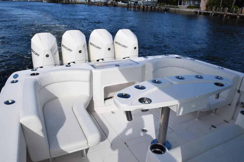 Slide: The Image of 2022 SeaVee 390Z boat with quad Mercury engines, featuring spacious seating and rod holders. - 14