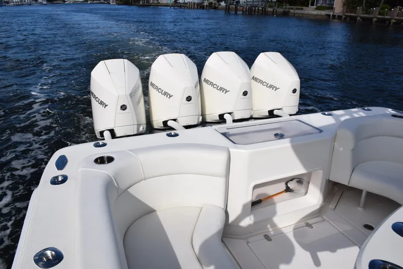 Slide: The Image of 2022 SeaVee 390Z boat with four Mercury outboard engines on a calm waterway. - 13