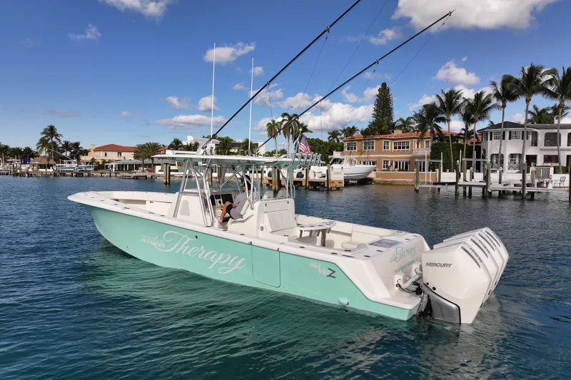 The Image of 2022 SeaVee 390Z boat with Mercury engines, docked in a scenic waterfront area. - 1