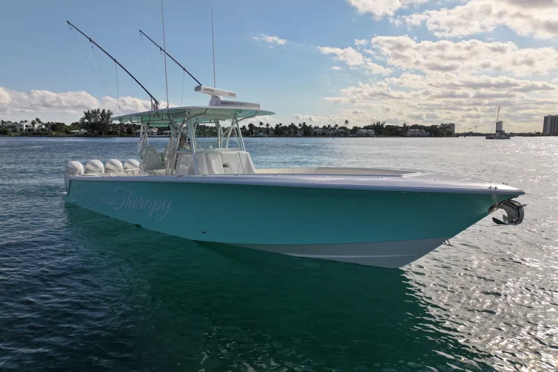 Slide: The Image of 2022 SeaVee 390Z boat on calm water, featuring sleek design and fishing rods. - 2
